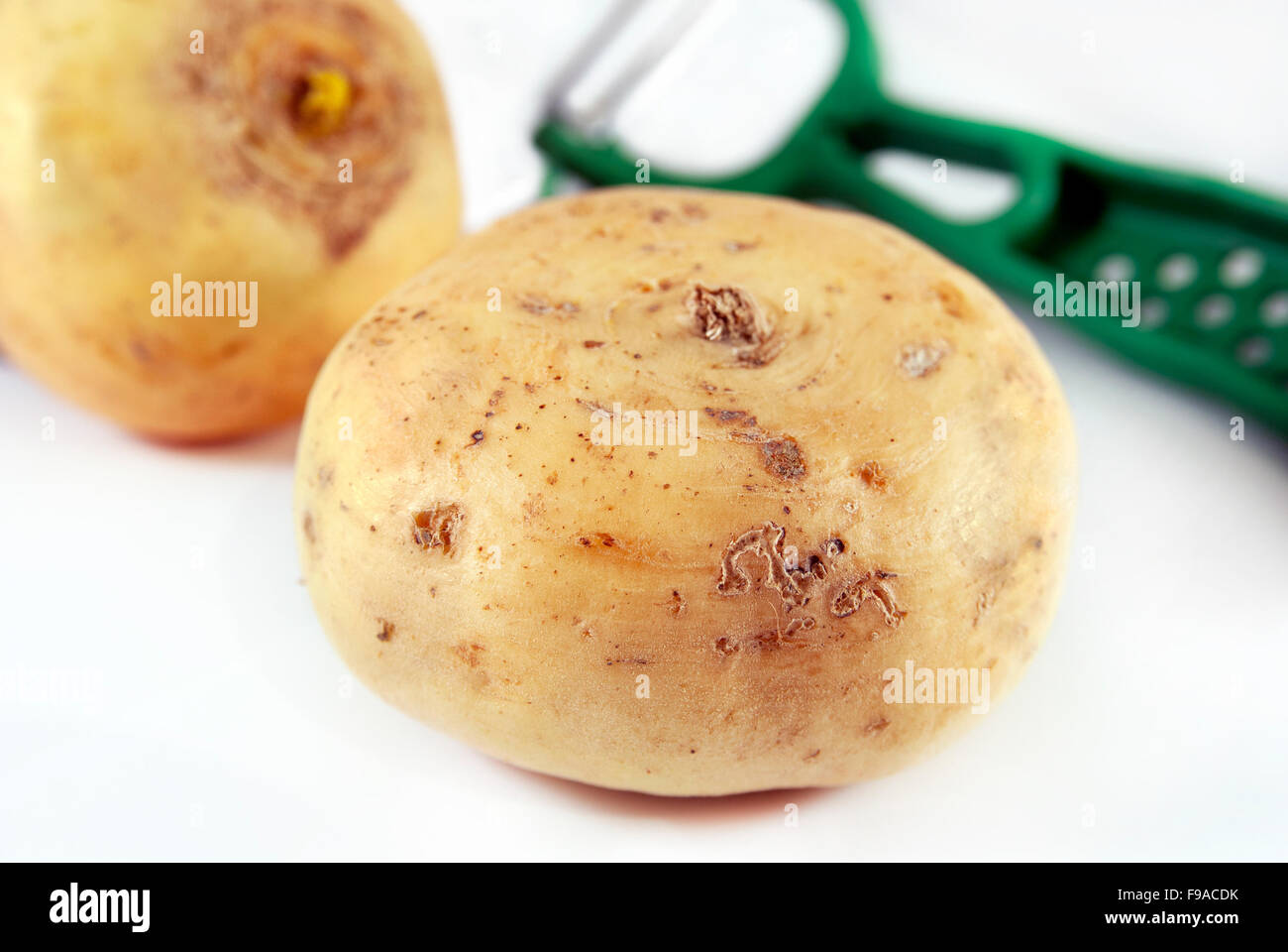 Turnip and a vegetable peeler Stock Photo