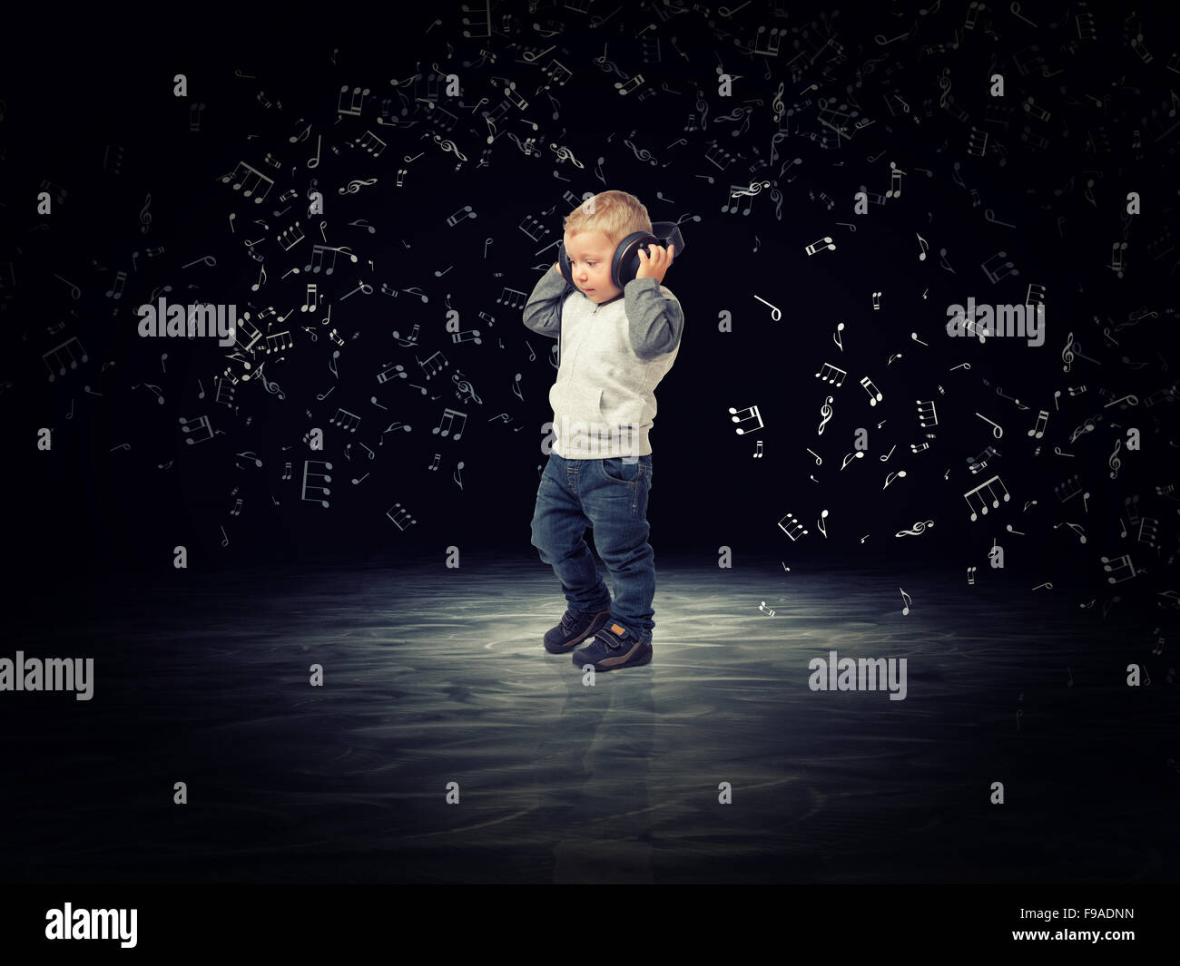 child with headphone and abstract music background Stock Photo