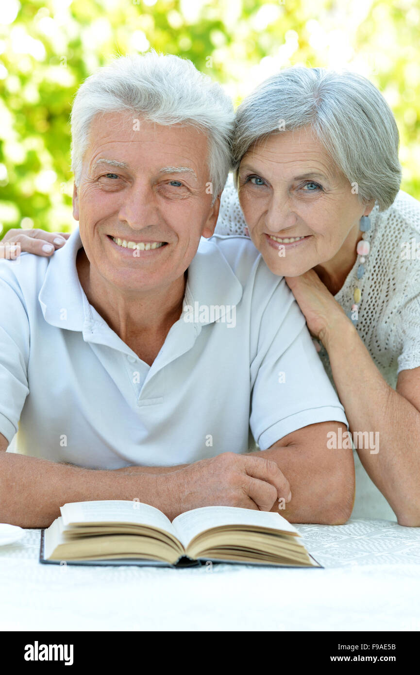 Beautiful happy old couple  and book Stock Photo