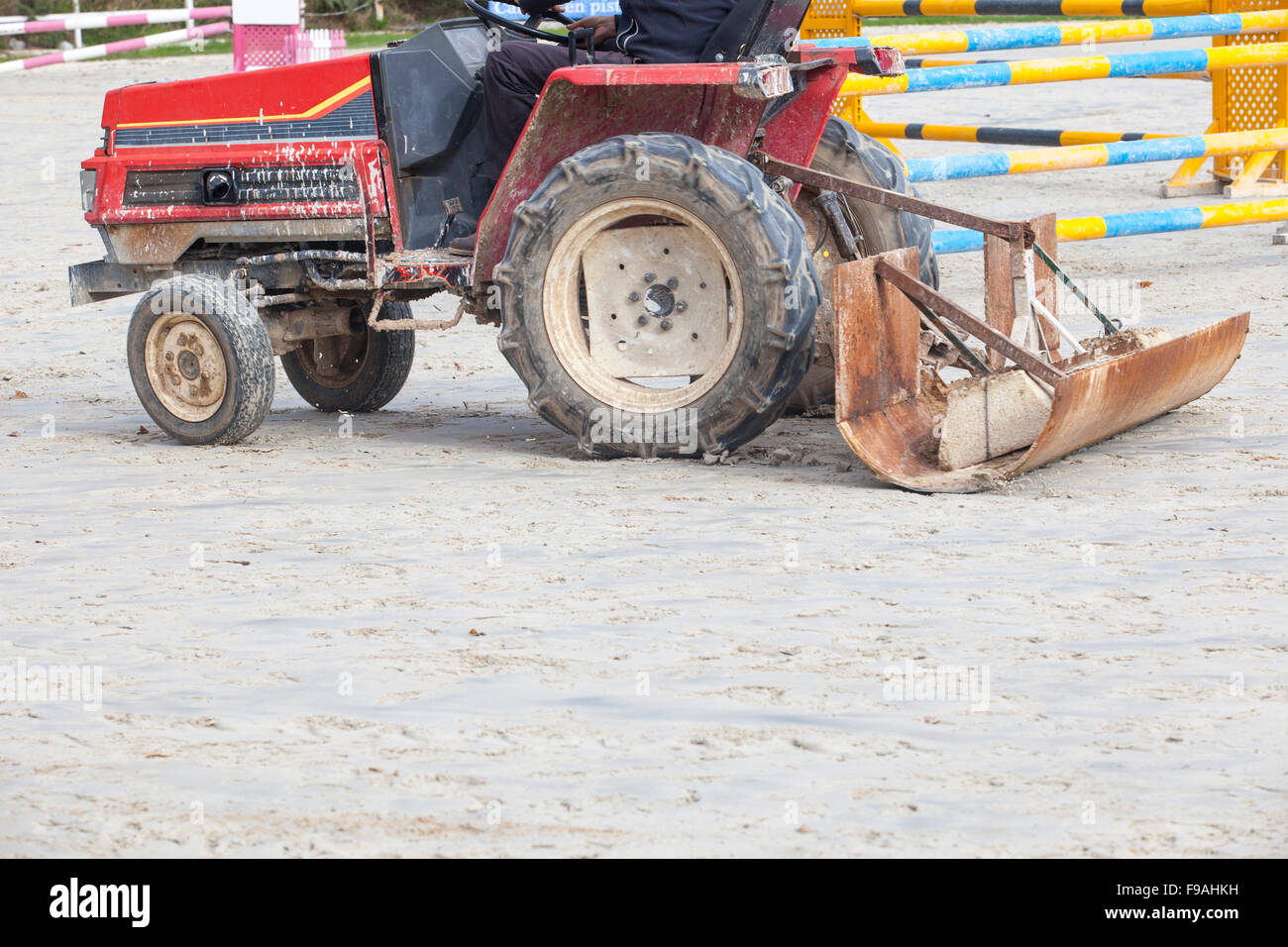 Smoothing tractor working at horse jumping competition Stock Photo