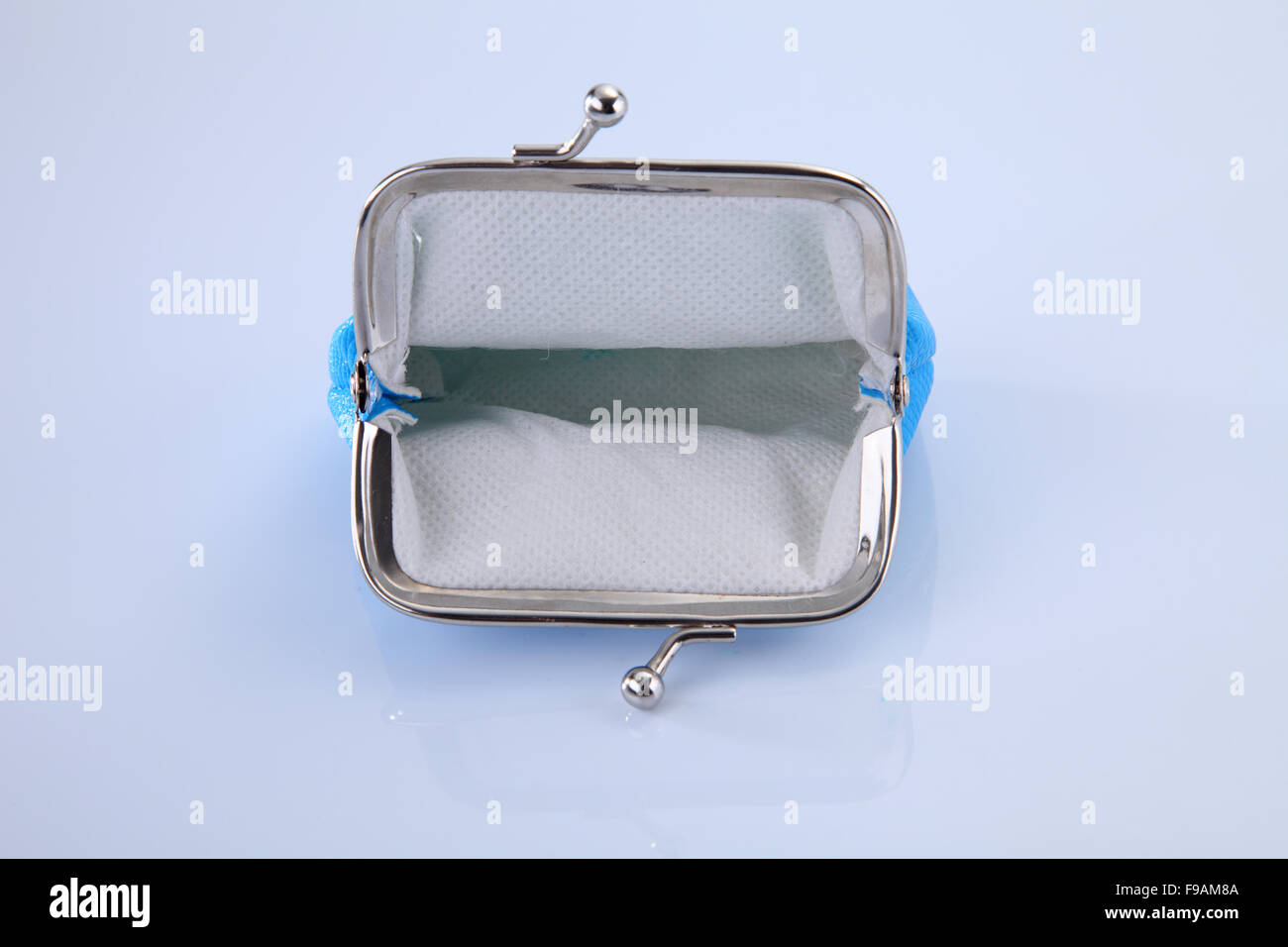 empty blue purse open on the white background Stock Photo - Alamy