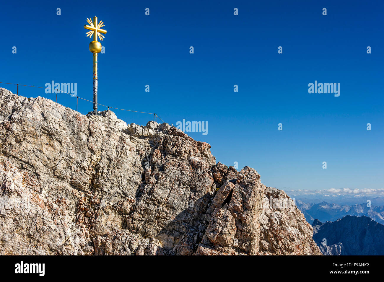 Gilded summit cross, Zugspitze, view towards Tyrol behind, Garmisch-Partenkirchen, Wetterstein, Eastern Alps, Upper Bavaria Stock Photo