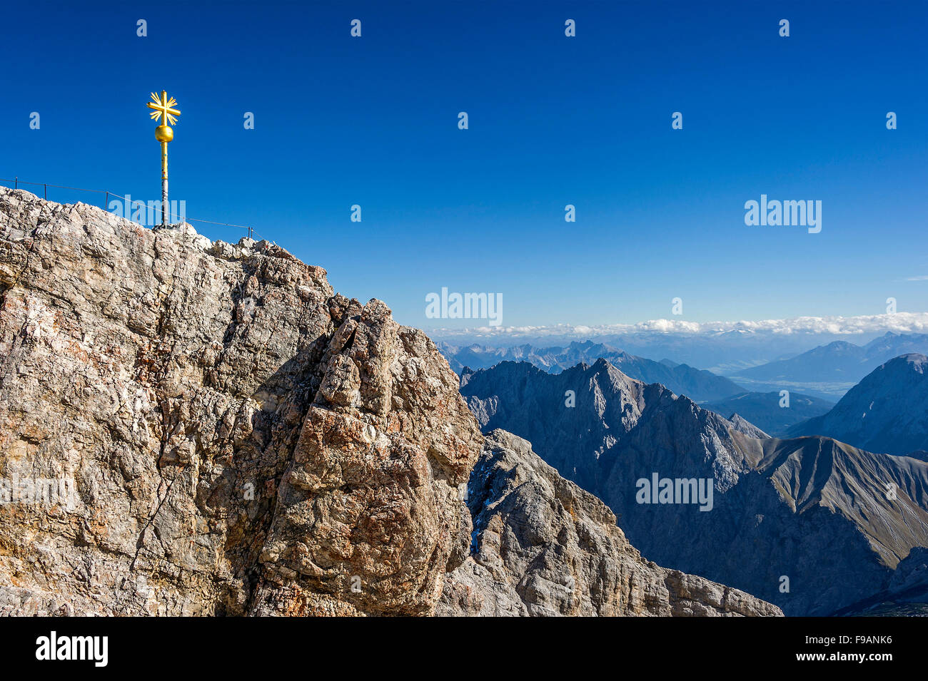 Gilded summit cross, Zugspitze, Mieminger Mountains in Tyrol behind, Garmisch-Partenkirchen, Wetterstein, Eastern Alps Stock Photo