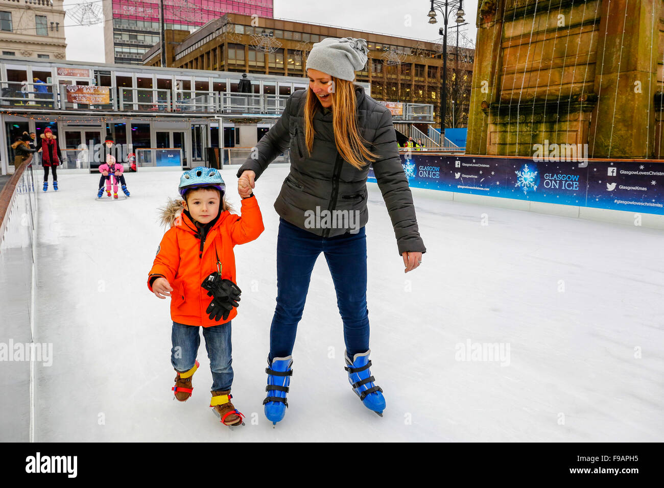 Glasgow, Scotland, UK. 15th Dec, 2015. Glasgow's annual  "Christmas on Ice" spectacular outdoor ice rink in George Square in the city centre attracts skaters of all ages and abilities. Those who are a little unsteady on the ice get a some help from parents and relatives. A fun way to have a break from Christmas shopping.Here adam Fyfe, aged 4 from Kirkintilloch is skating with a little help from his mother, Angela. Credit:  Findlay/Alamy Live News Stock Photo