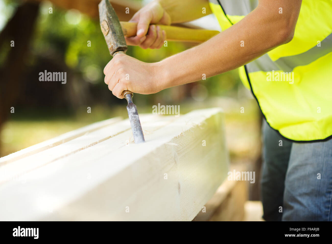 Construction worker is working with wooden beam Stock Photo - Alamy