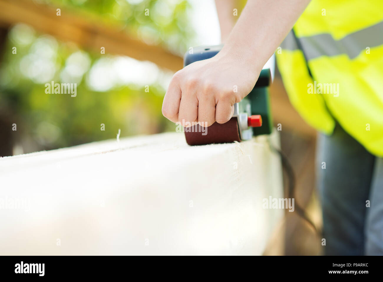 Construction worker is working with wooden beam Stock Photo - Alamy