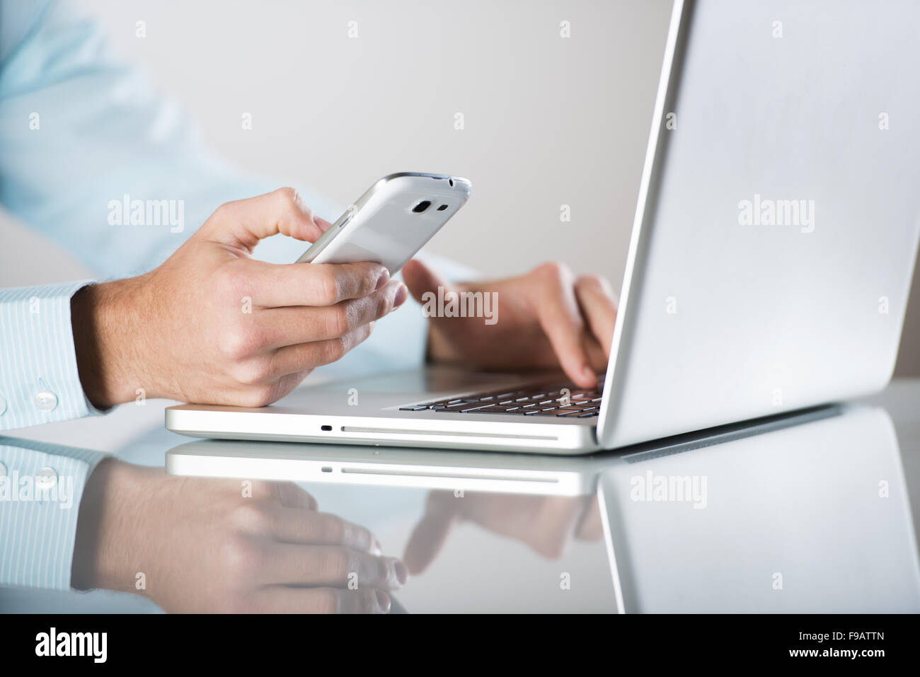 Businessman uses the new media technologies and devices to work successfully Stock Photo