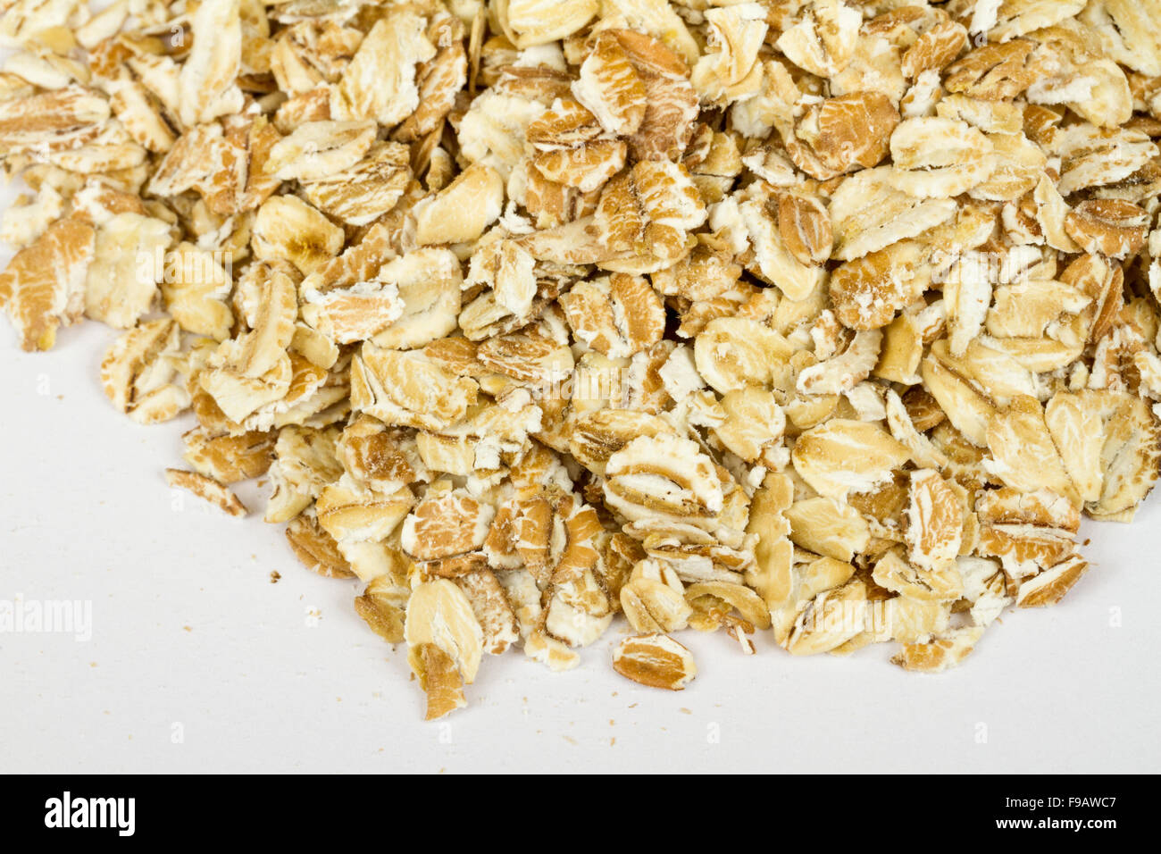 Heap of dry rolled oats isolated on white background Stock Photo Alamy