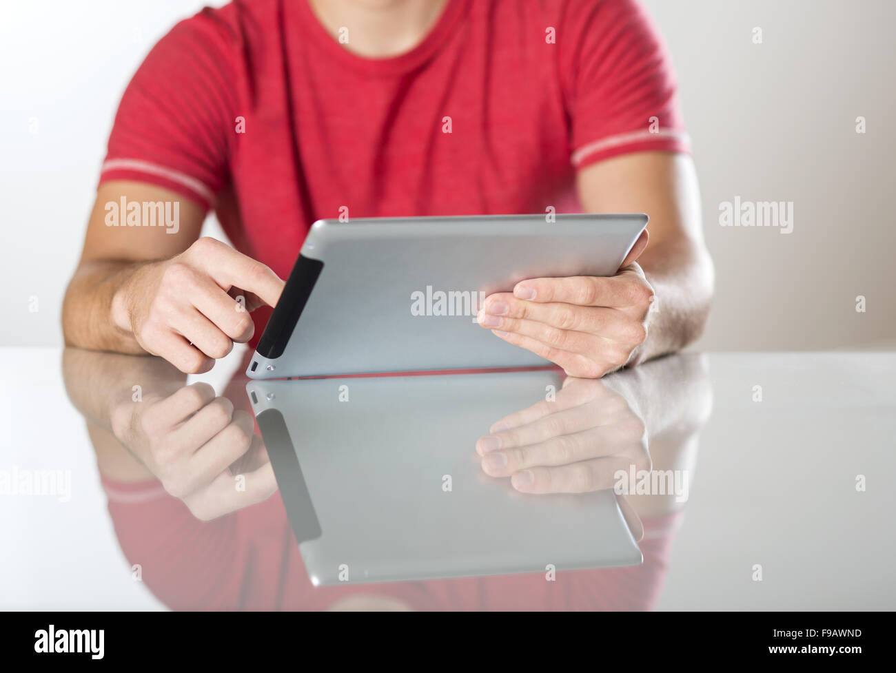 Detail of hands with tablet computer in studio Stock Photo - Alamy