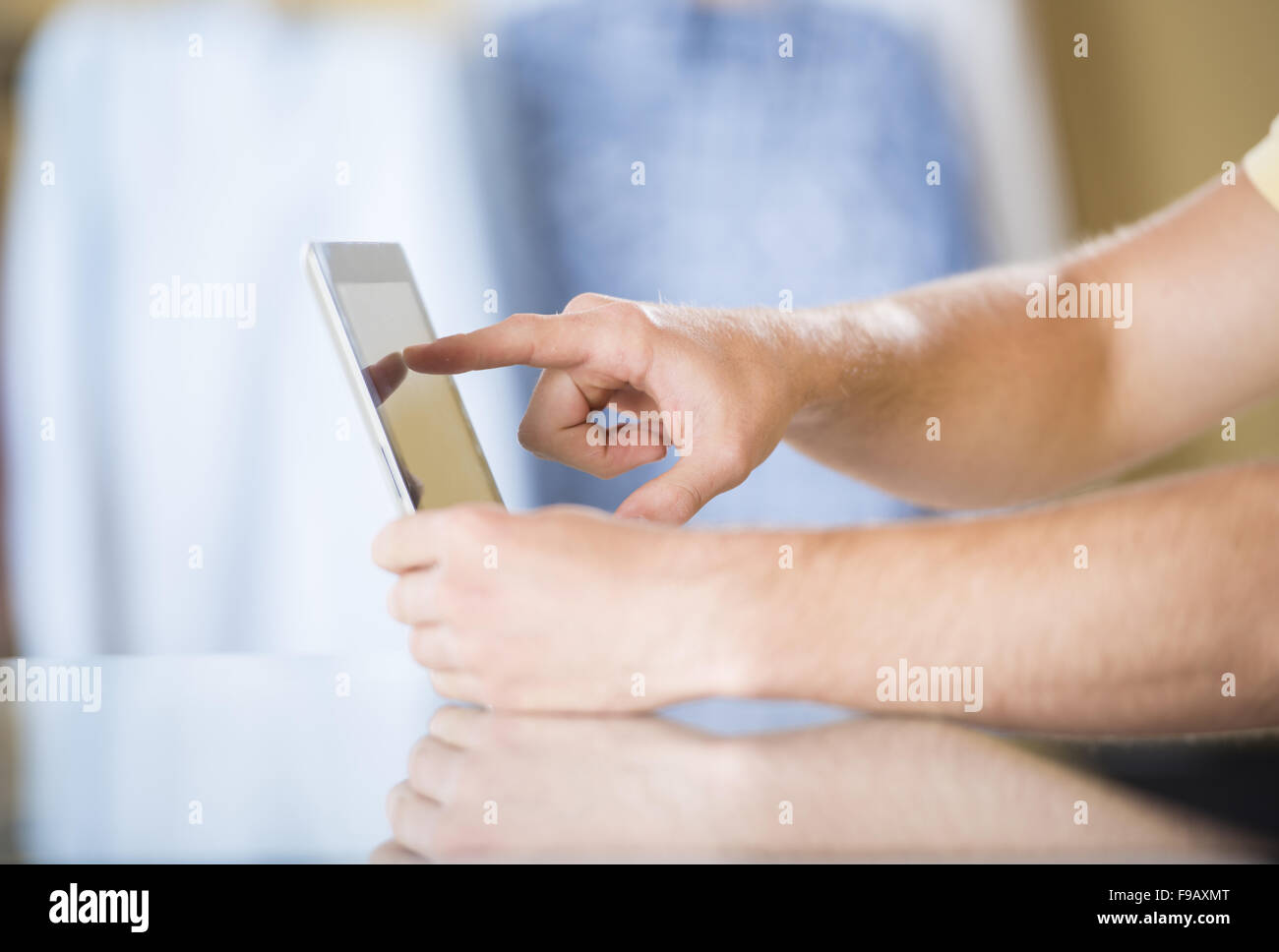Detail of hands with tablet computer in studio Stock Photo - Alamy