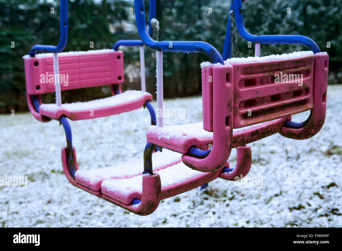 dirty swing on playground in the snow Stock Photo Alamy
