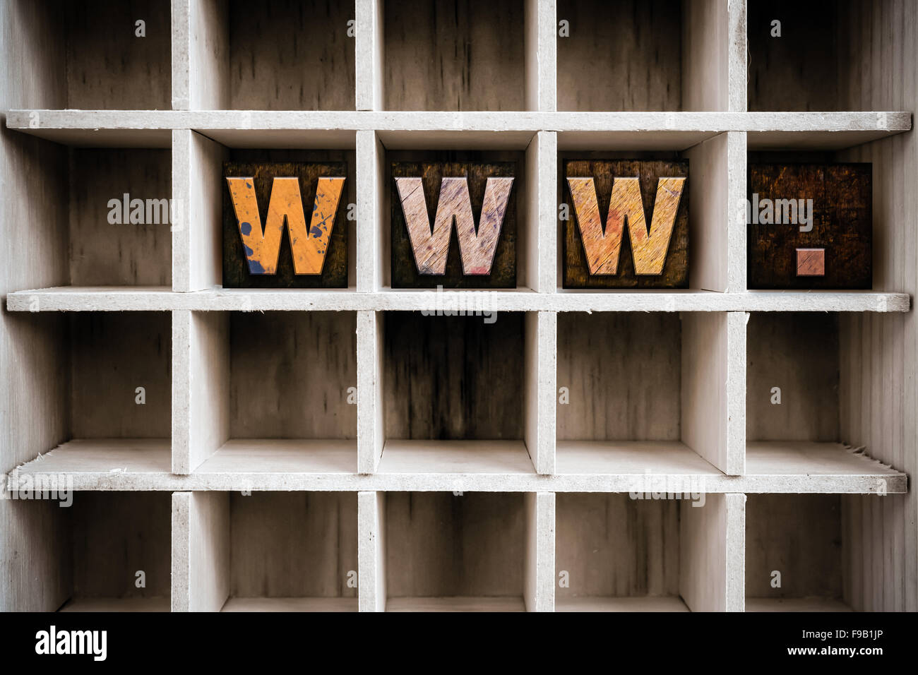 The word "WWW" written in vintage ink stained wooden letterpress type in a partitioned printer's drawer. Stock Photo