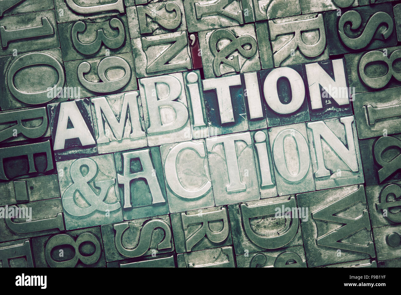 ambition and action words concept made from metallic letterpress blocks on letters background Stock Photo