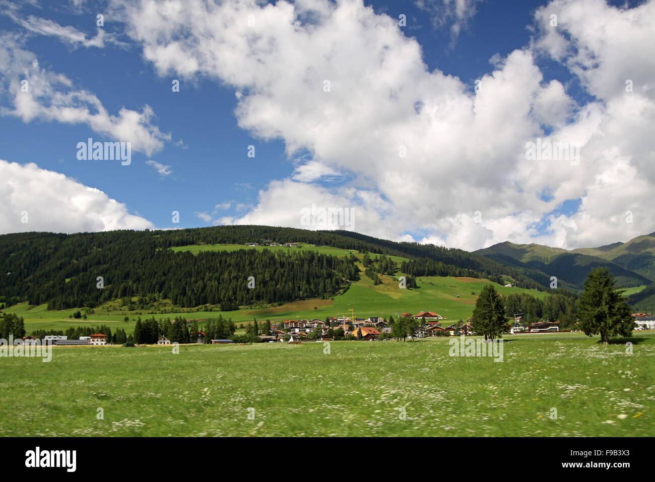 View of a village in the Alps during the summer Stock Photo - Alamy
