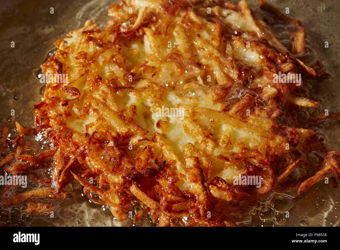 A latke frying - Eastern European Jewish style potato pancakes served
