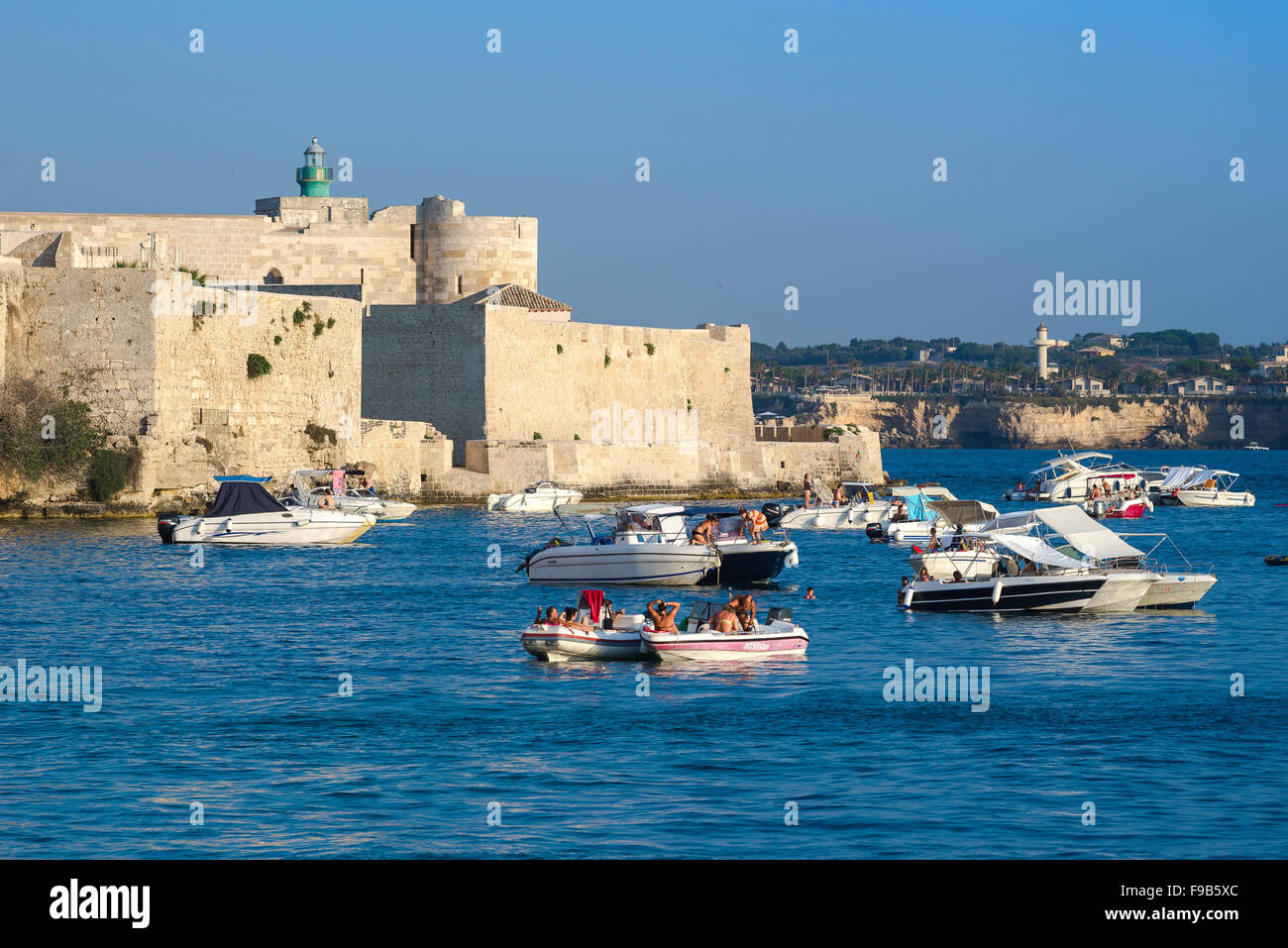 Ortigia harbor Sicily, view of Sicilians relaxing on their leisure boats in Ortigia harbour, Syracuse (Siracusa) Sicily. Stock Photo