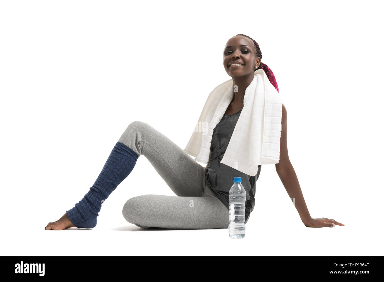 Athletic girl with a bottle of water and towel Stock Photo - Alamy