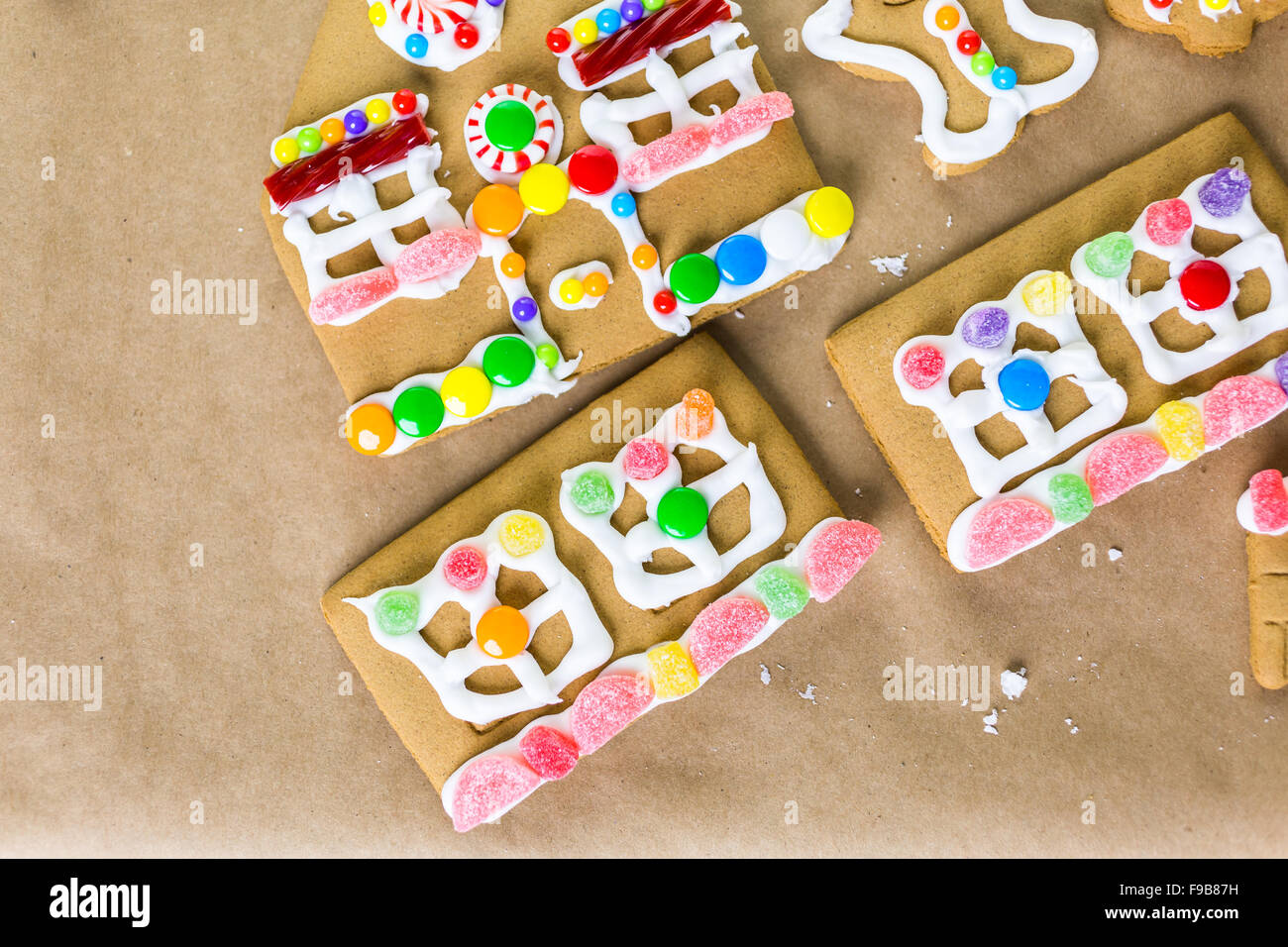 Decorating gingerbread house with royal icing and colorful candies ...