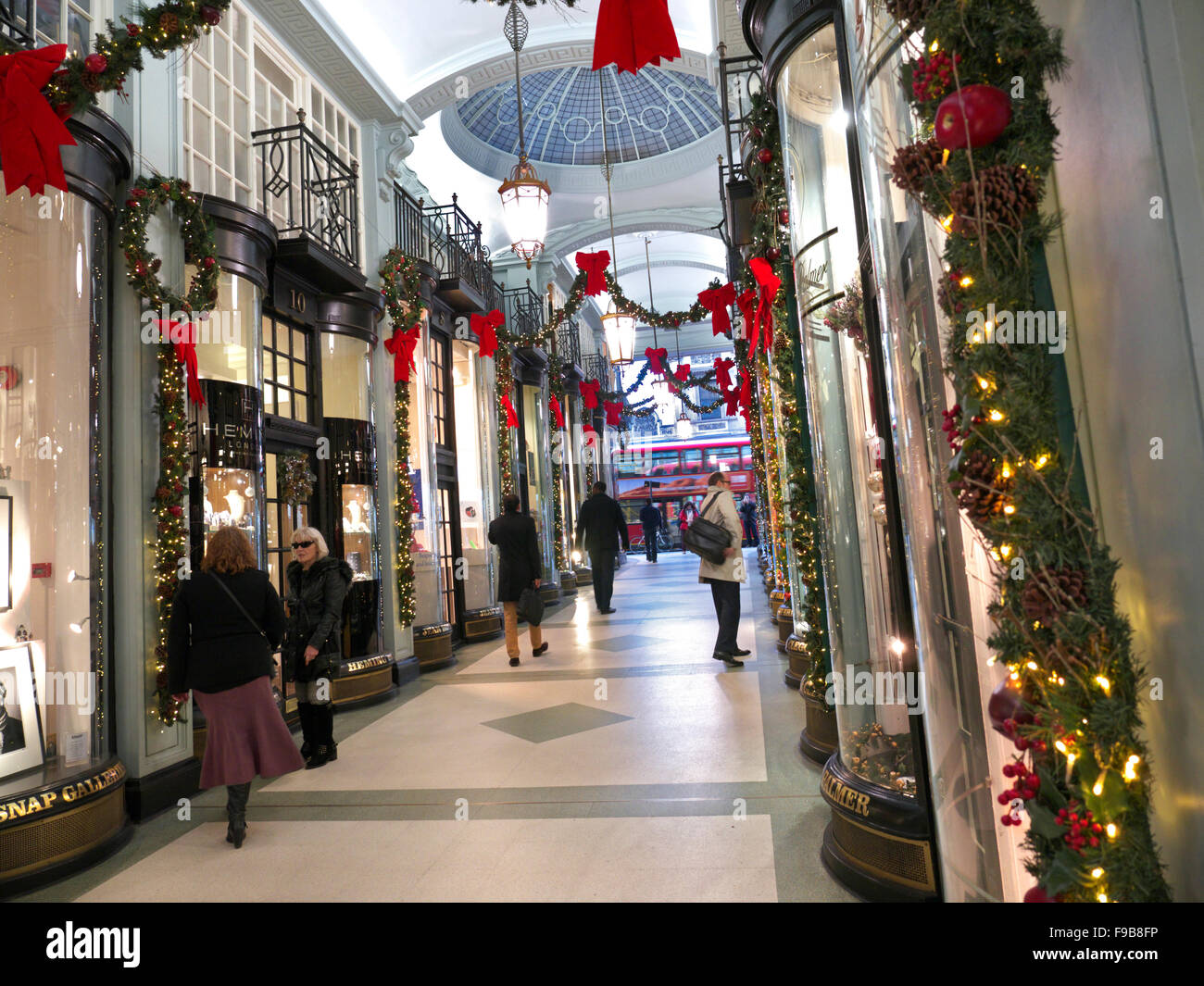 Piccadilly Arcade with shoppers decorated at Christmas time Piccadilly  London UK Stock Photo