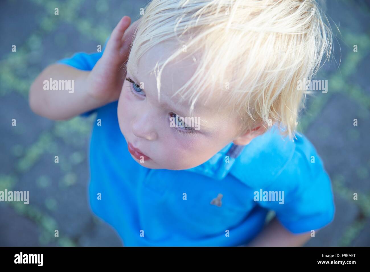 MODEL RELEASED. Boy with blonde hair, high angle view. Stock Photo