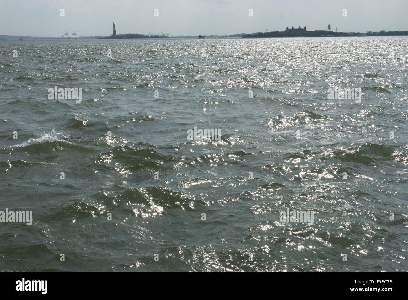 New York harbor choppy water with Statue of Liberty and Ellis Island Stock Photo