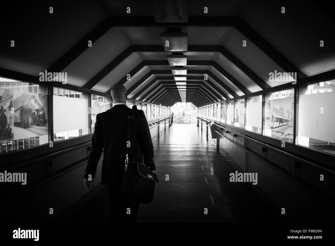 A man with a suitcase walking through the tunnel Stock Photo
