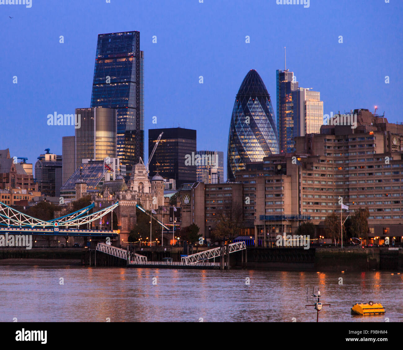 The Cheese Grater and the Gherkin dominate  Tower Bridge and the City of London skyline, early morning Stock Photo