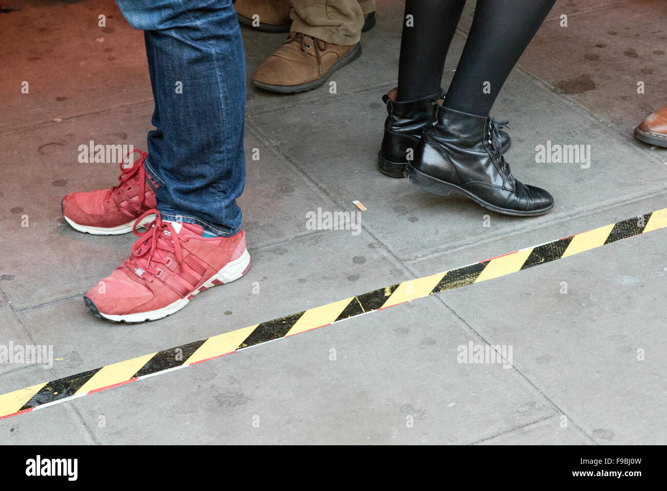 London pub customers stand outside behind property demarcation line, London, England,UK, Stock Photo