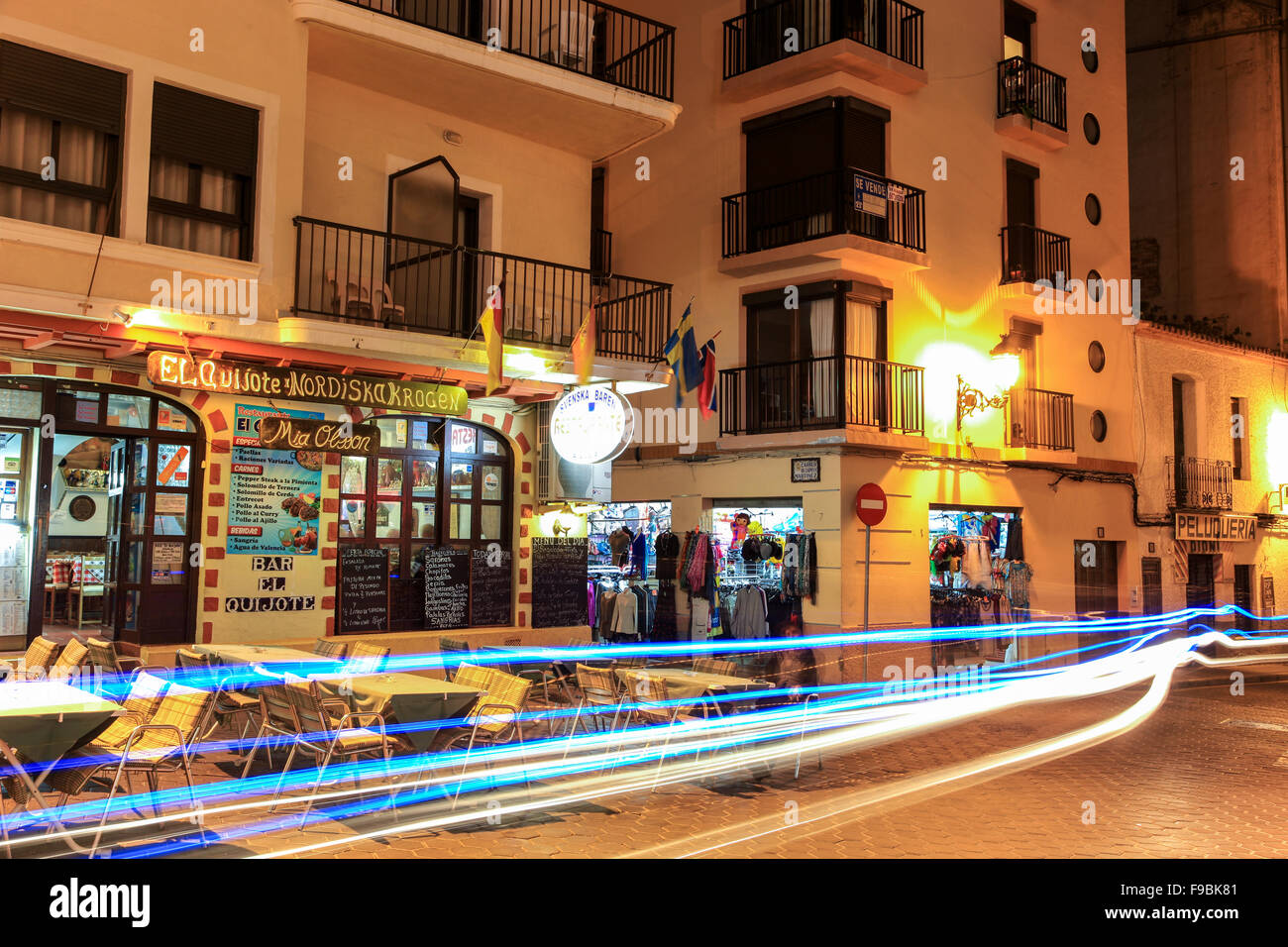 Light streaks at night in the old town of Benidorm outside El Quijote Nordiska Krogen Norwegian bar restaurant Stock Photo