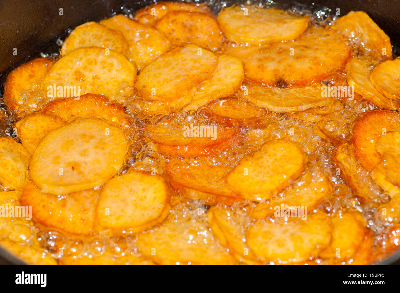 Deep-frying Sweet Potato Chips (Camote Frito) is a typical Peruvian dish Stock Photo