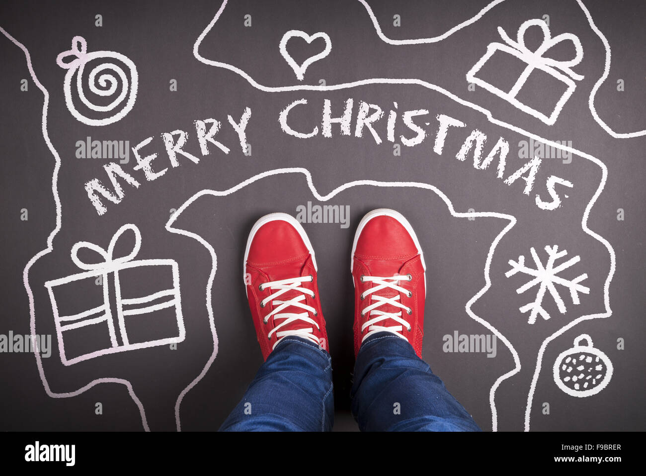 Christmas concept with red shoes and white chalk Stock Photo