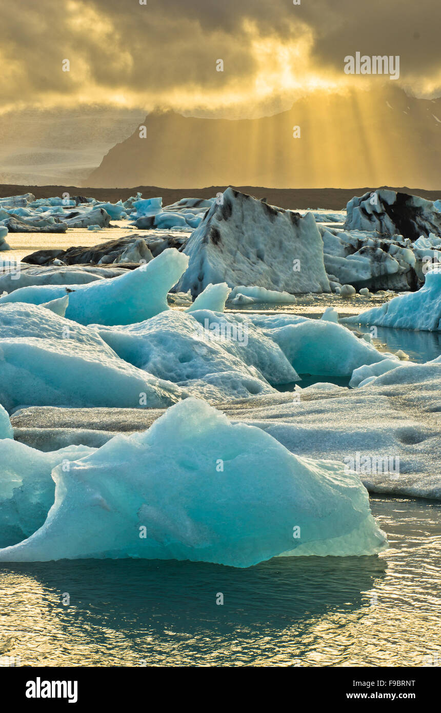 Melting of icebergs at Jokulsarlon glacier lagoon at sunset Stock Photo ...