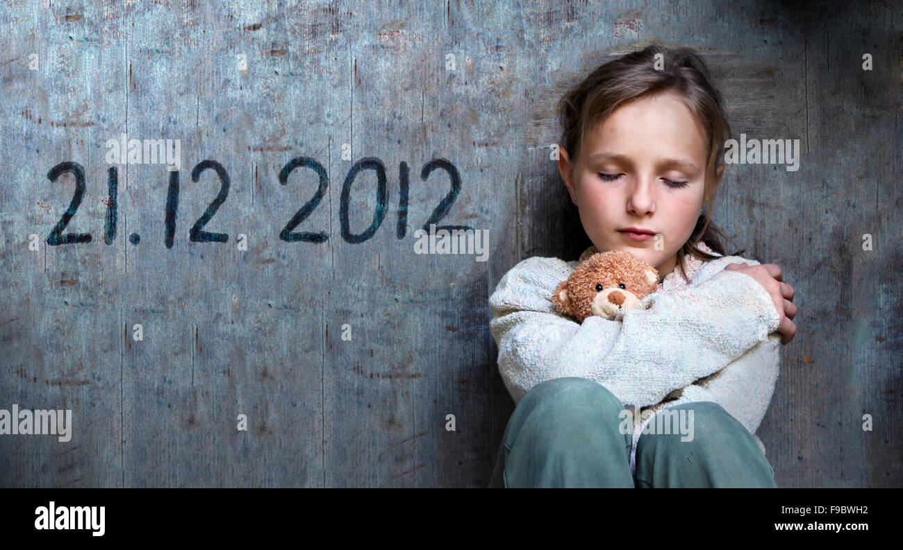 Frightened child with date of end of the world. Stock Photo