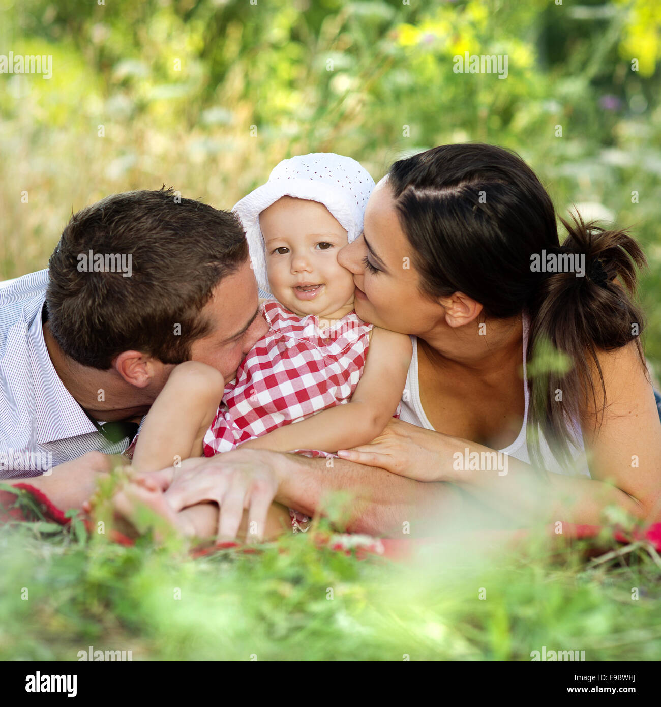Happy young family spending time outdoor on a summer day Stock Photo