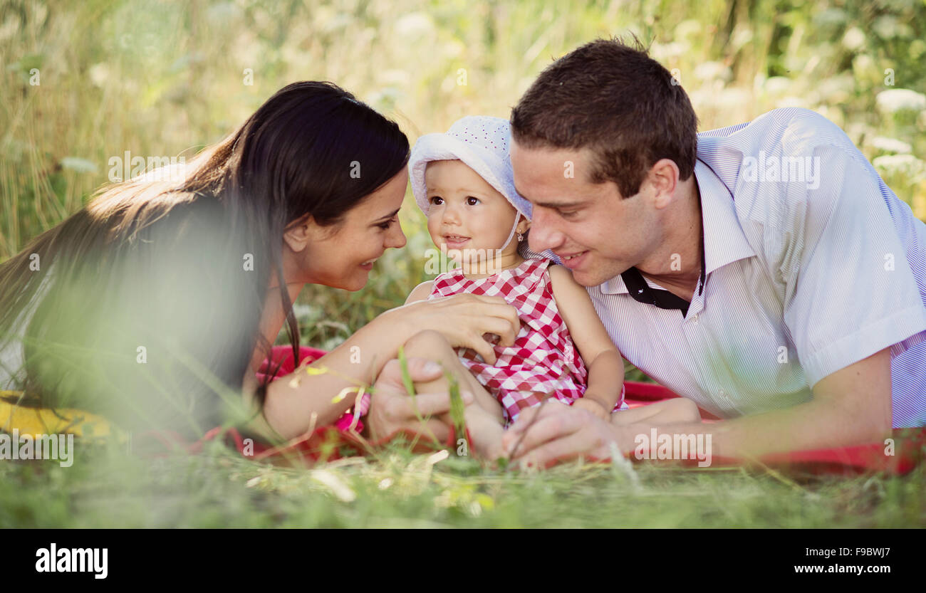 Happy young family spending time outdoor on a summer day Stock Photo