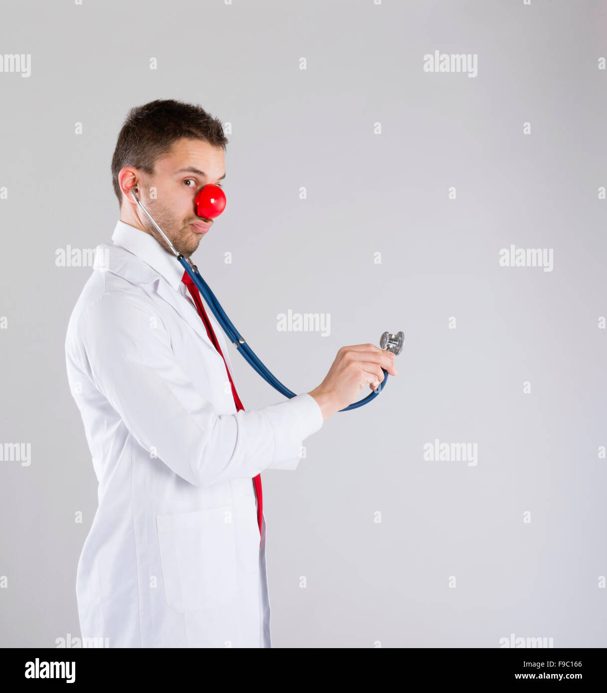 Portrait of funny doctor with red nose Stock Photo