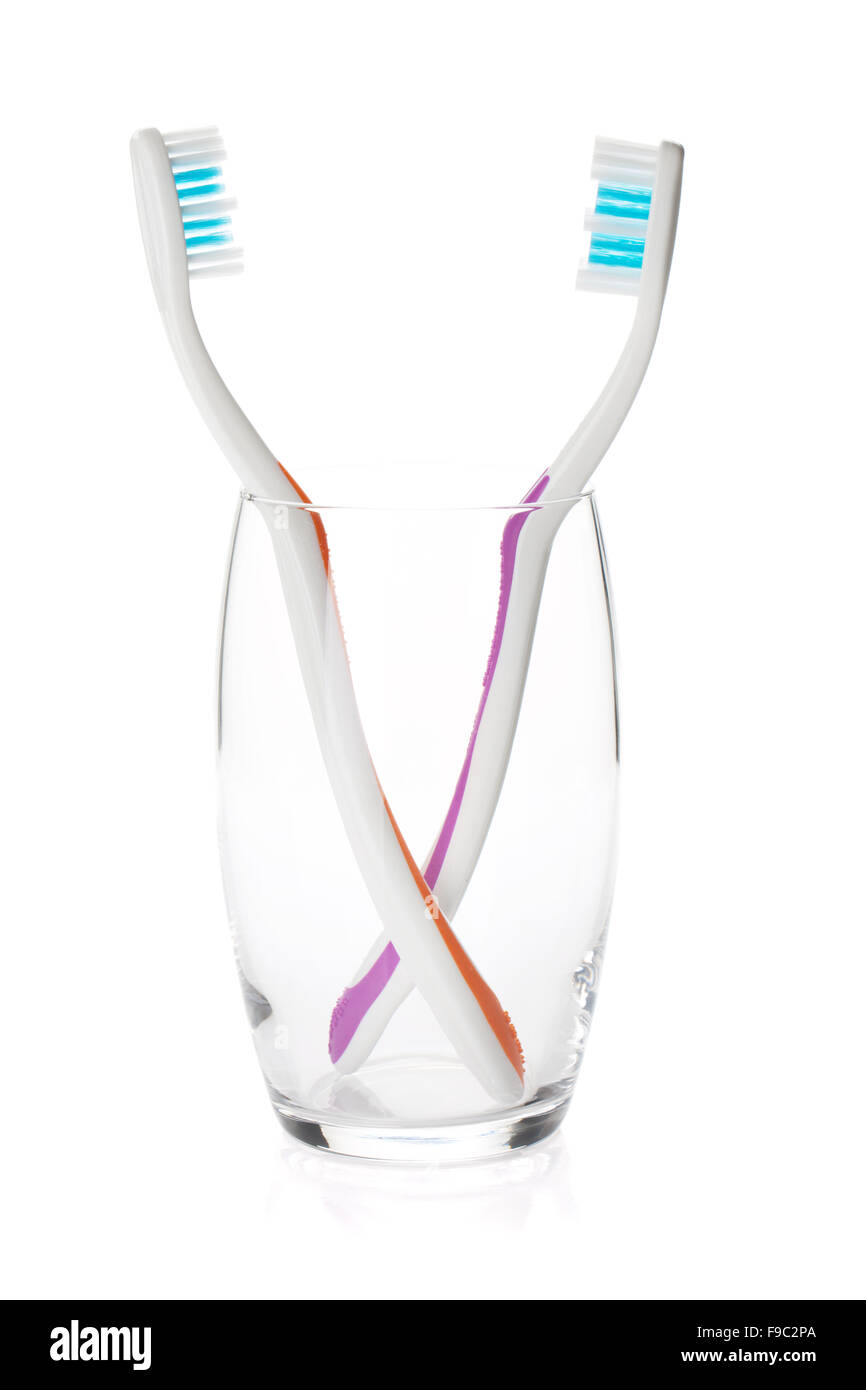 Two toothbrushes in a glass. Isolated on white background Stock Photo ...