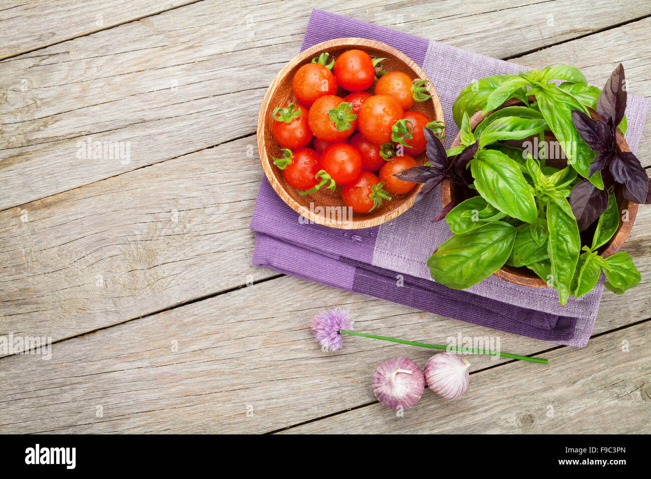 Fresh farmers tomatoes and basil on wood table with copy space Stock ...