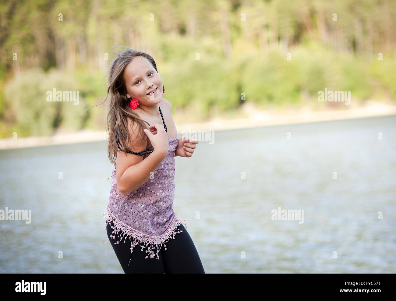Happy little girl is playing in the green sunny park Stock Photo - Alamy