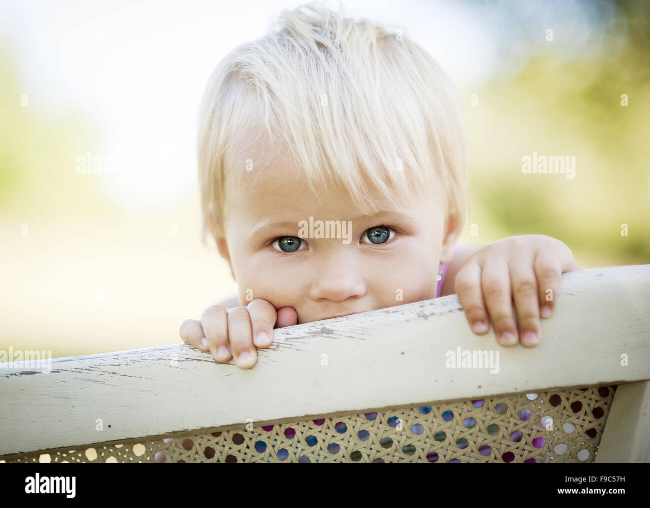 Happy little girl is playing in the green sunny park Stock Photo - Alamy