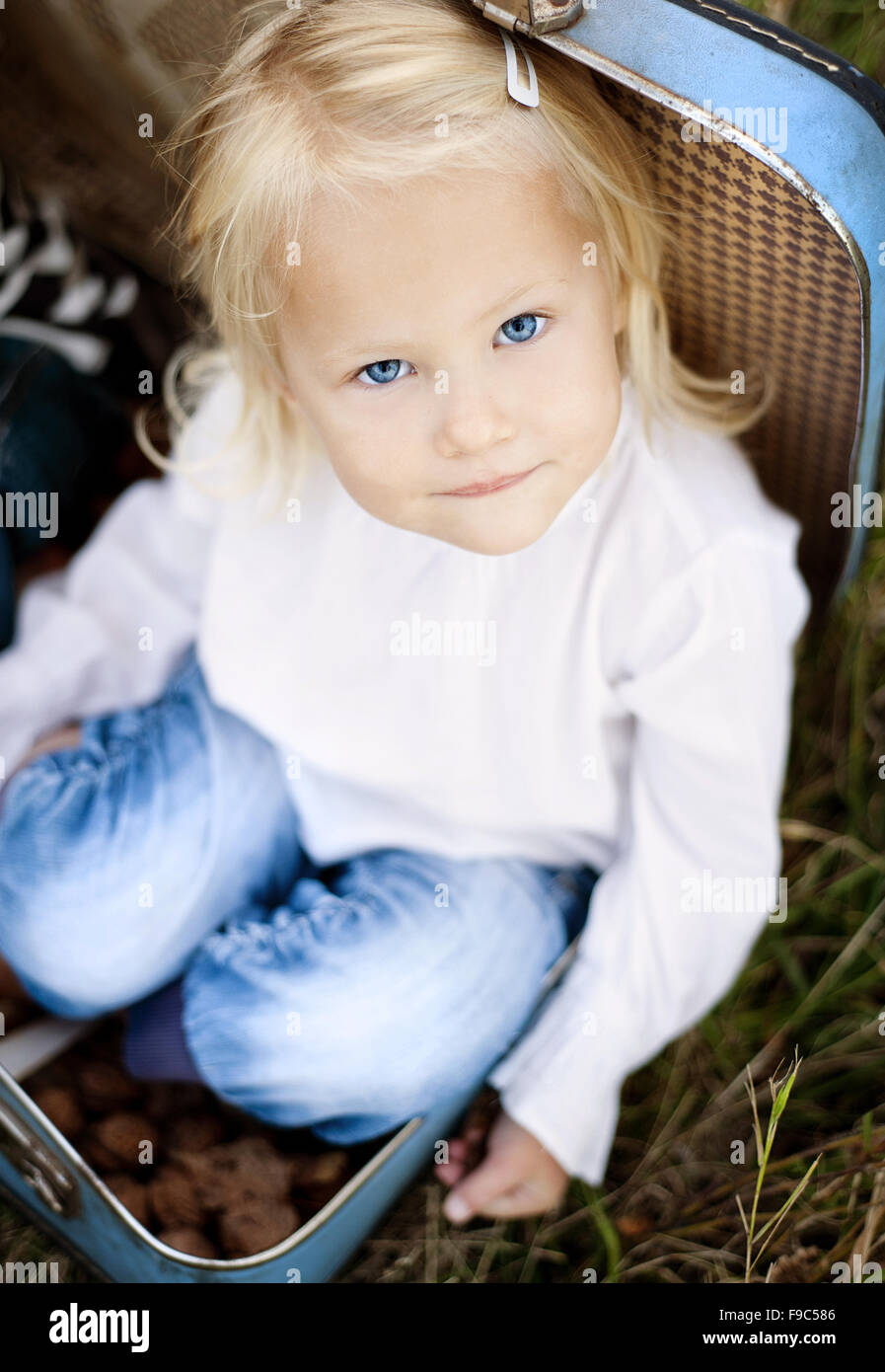 Happy little girl is playing in the green sunny park Stock Photo - Alamy