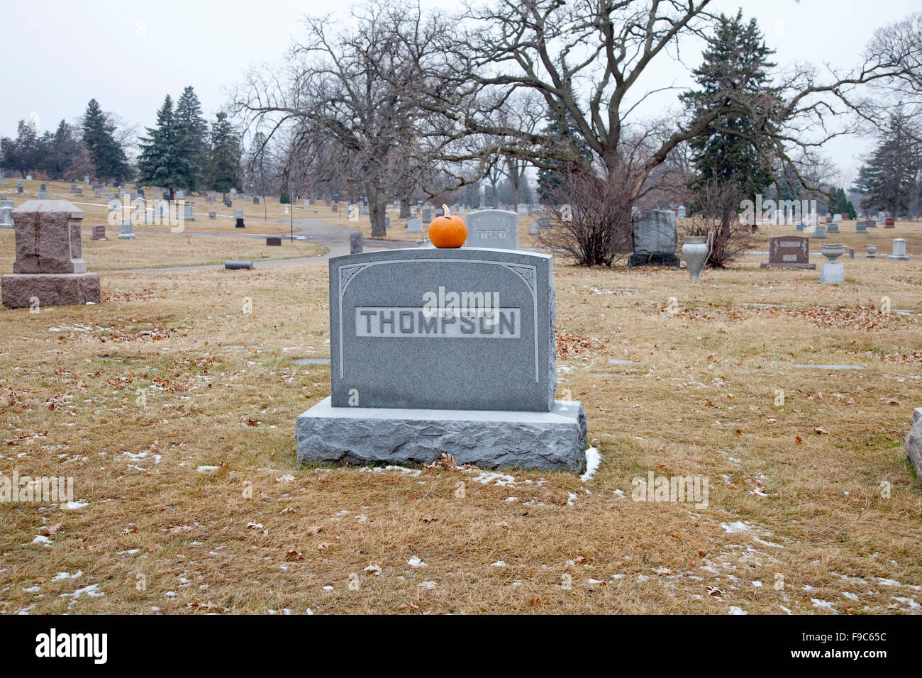 Pumpkin resting on top of cemetery gravestone. Crystal Lake Cemetery