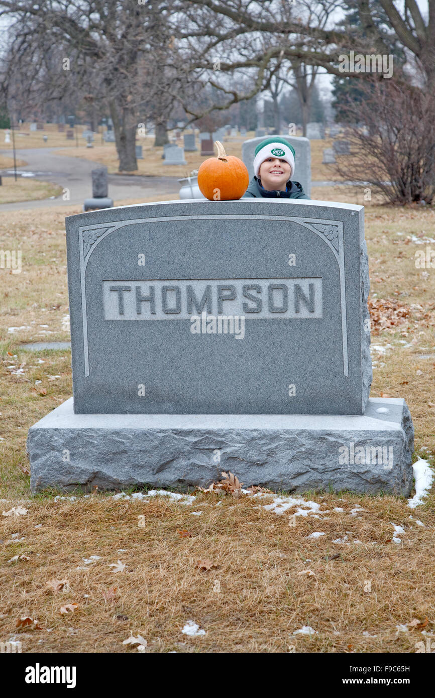 Pumpkin and boys head atop of cemetery gravestone Crystal Lake Cemetery