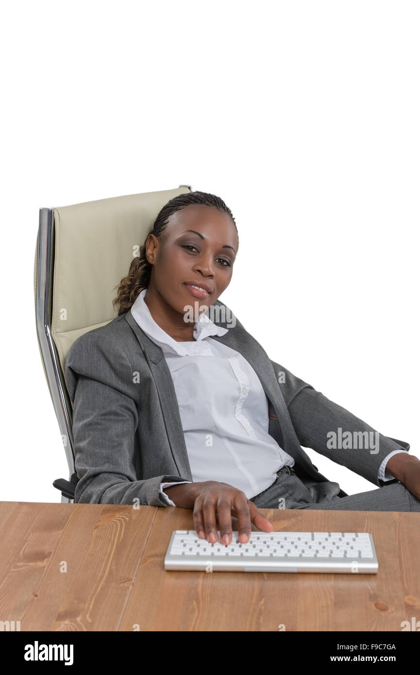 African business woman sitting at her desk and working isolated on ...