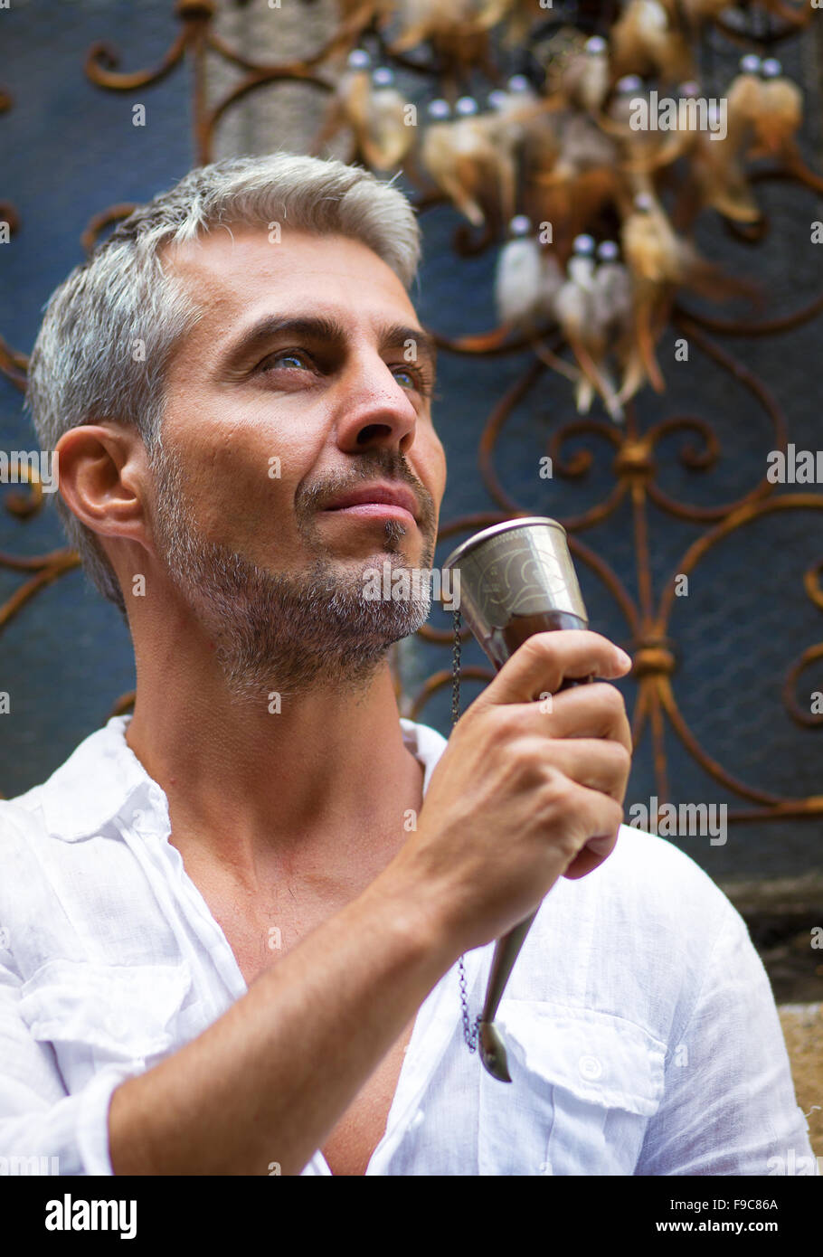 Man drinking beer  and medieval mead horn in hand. Toast concept Stock Photo