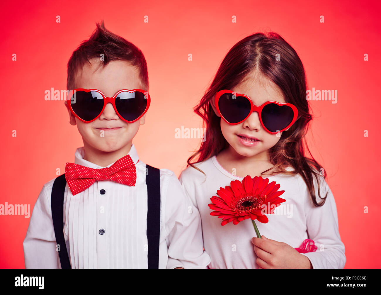 Portrait of little boy and girl posing at camera Stock Photo - Alamy