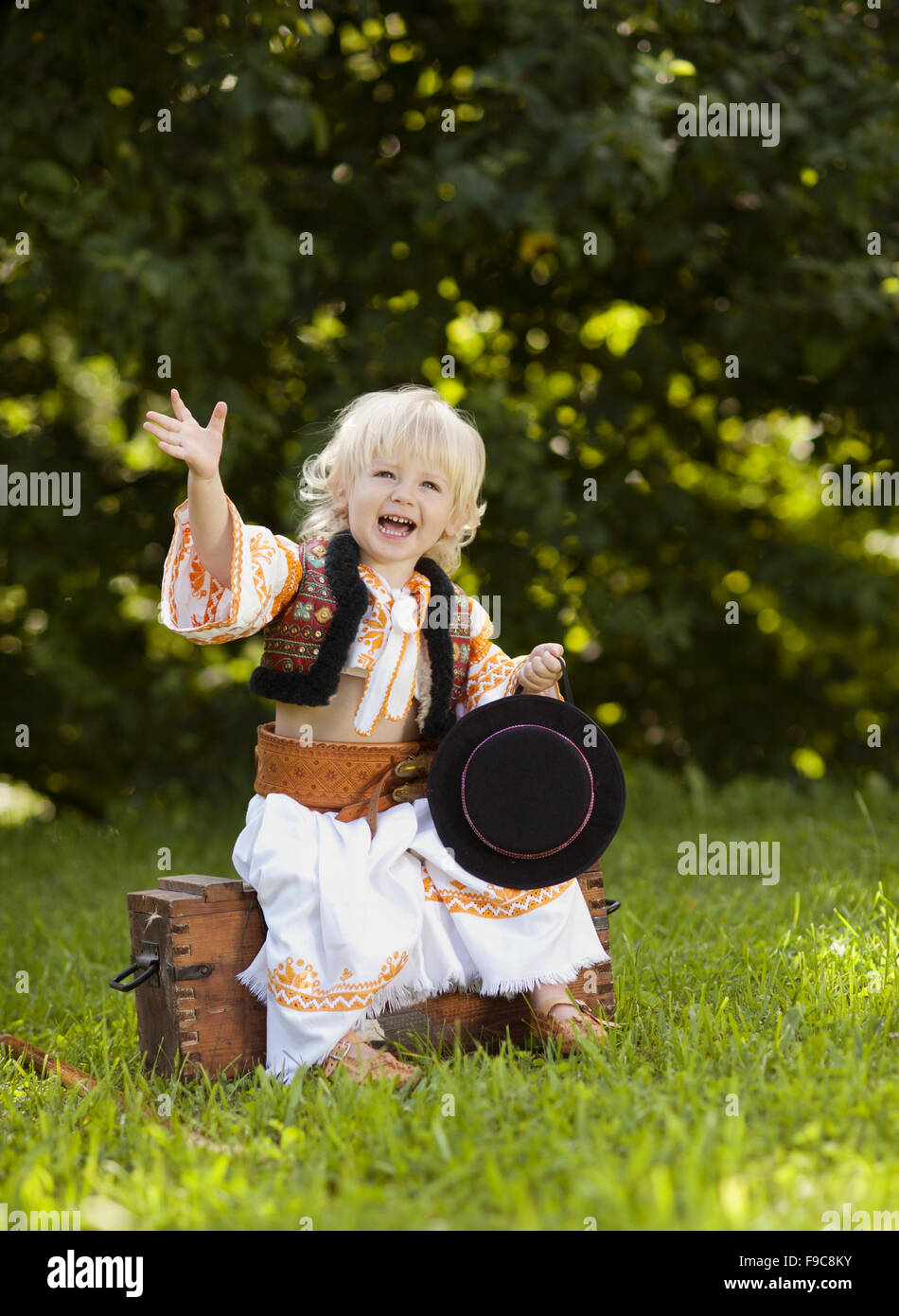 Cute child in folk costume from Easten Europe. Stock Photo