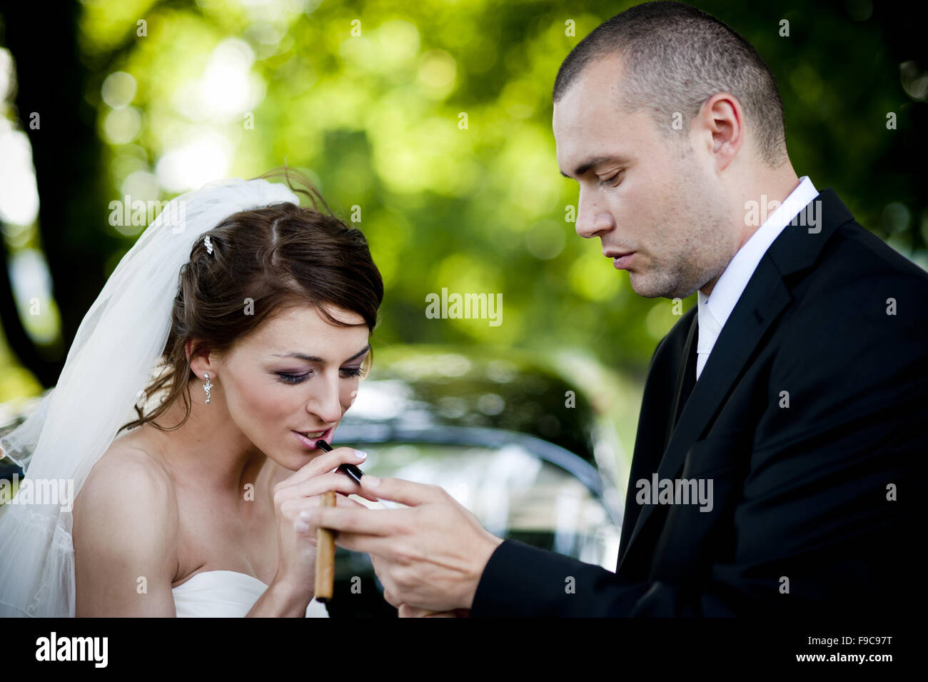 Happy bride and groom in a black car on wedding day Stock Photo - Alamy
