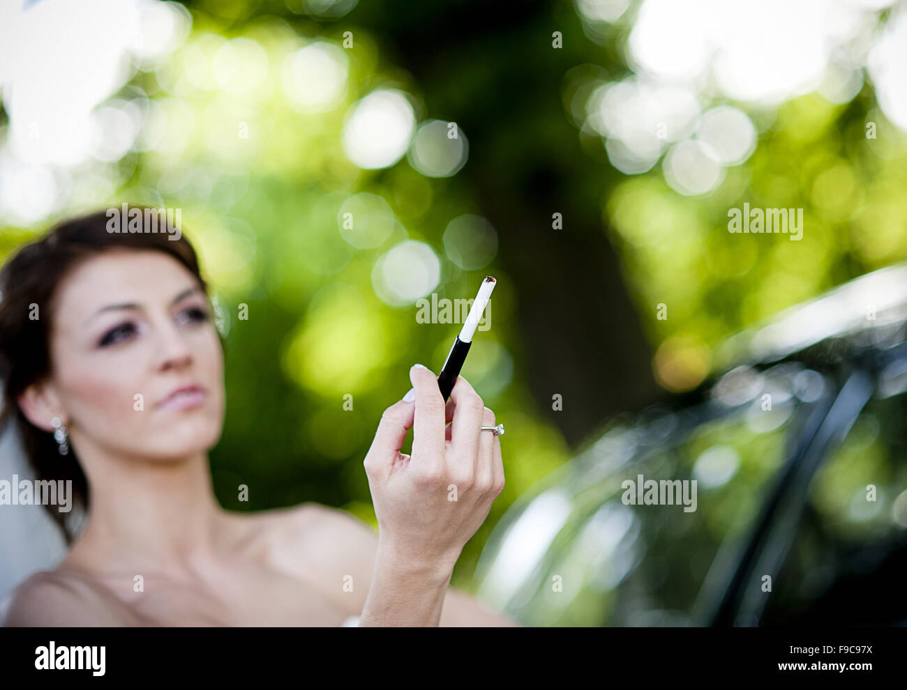 Happy bride and groom in a black car on wedding day Stock Photo - Alamy
