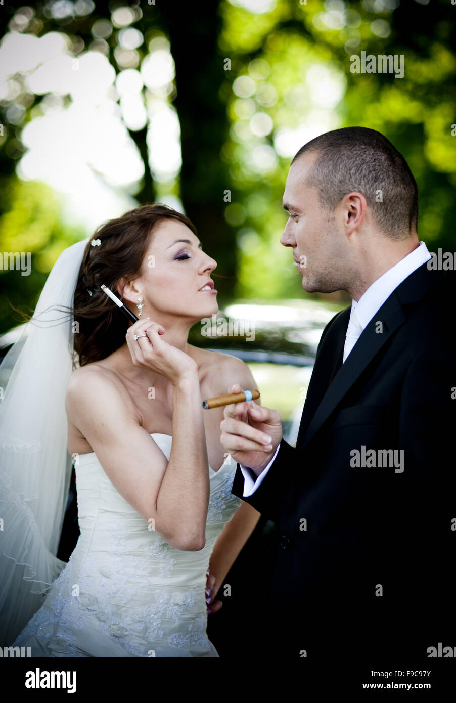 Happy bride and groom in a black car on wedding day Stock Photo - Alamy